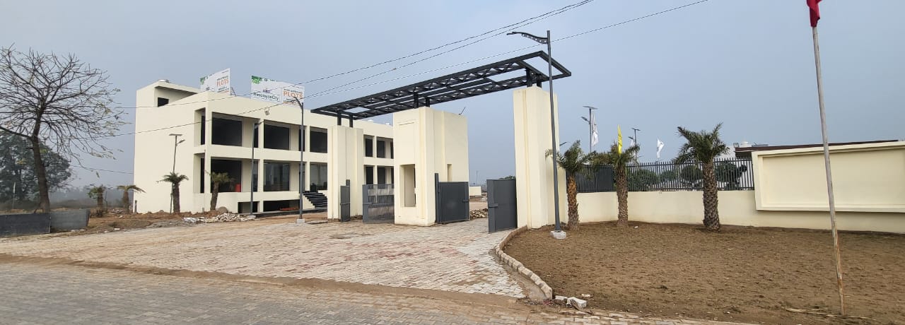 Residential township with a gated entrance and modern villas under development.